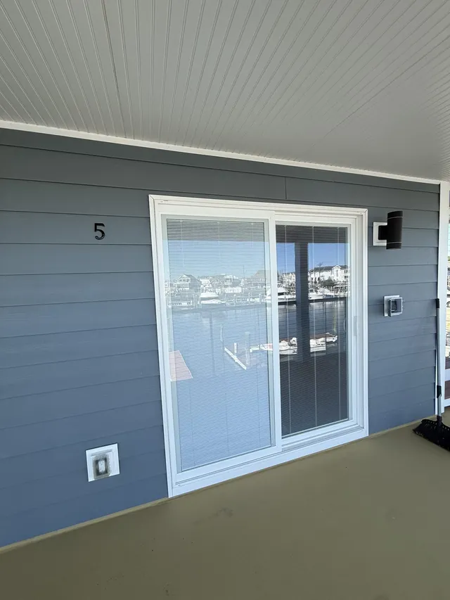Unit 5 sliding-glass entrance beside the harbor walkway