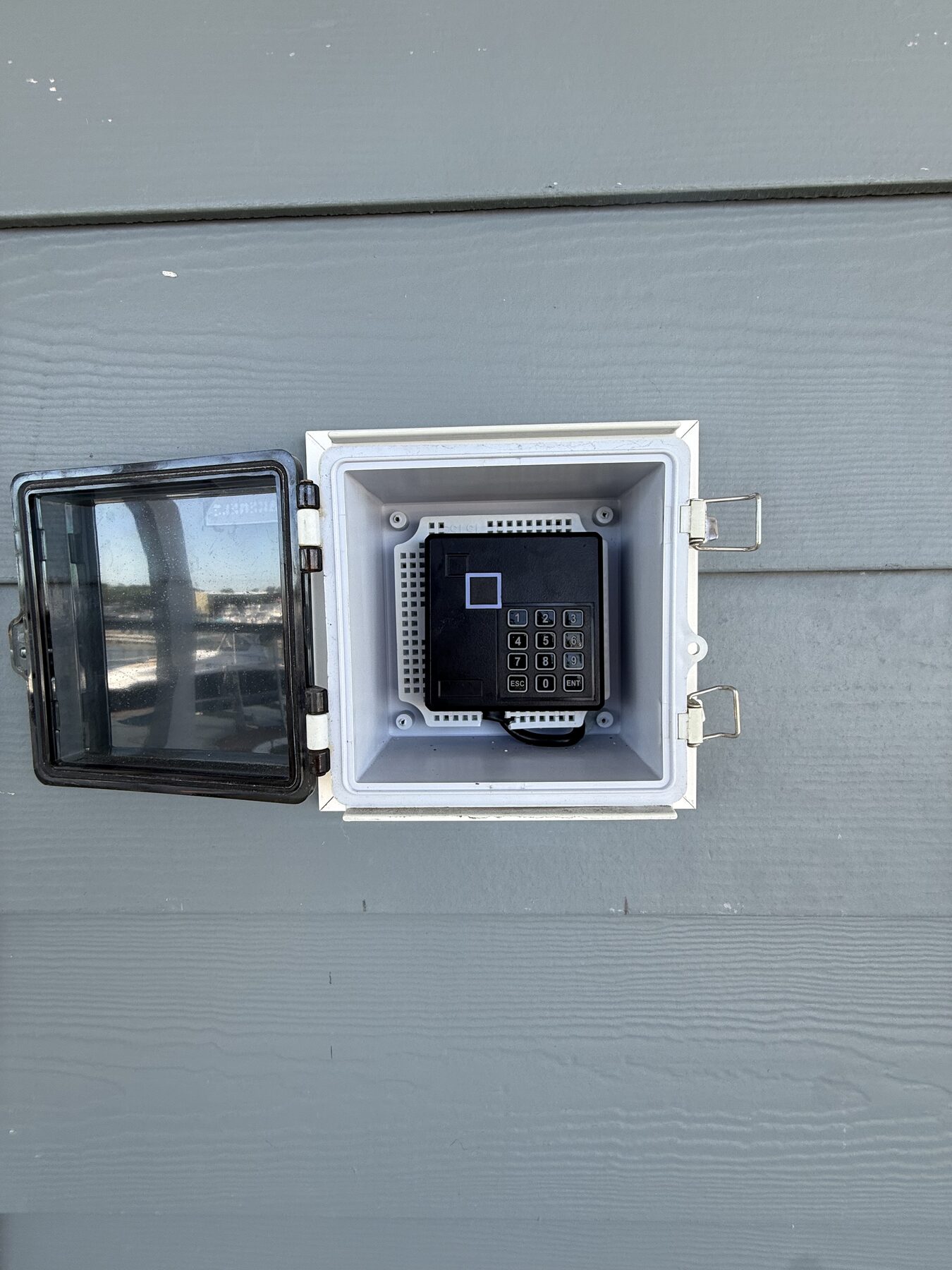 Weatherproof digital keypad lock used for contactless guest check-in at Yacht Avenue Condos